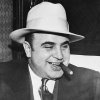 -al-capone-smokes-a-cigar-on-the-train-carrying-him-to-the-federal-penitentiary-in-atlanta-whe...jpg