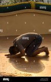 laos-pakse-the-temple-vat-phou-salao-man-prayer-bowing-2F97JGP.jpg