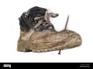 an-old-work-boot-with-a-nail-construction-workers-damaged-work-clothes-white-background-2A3DXK...jpg